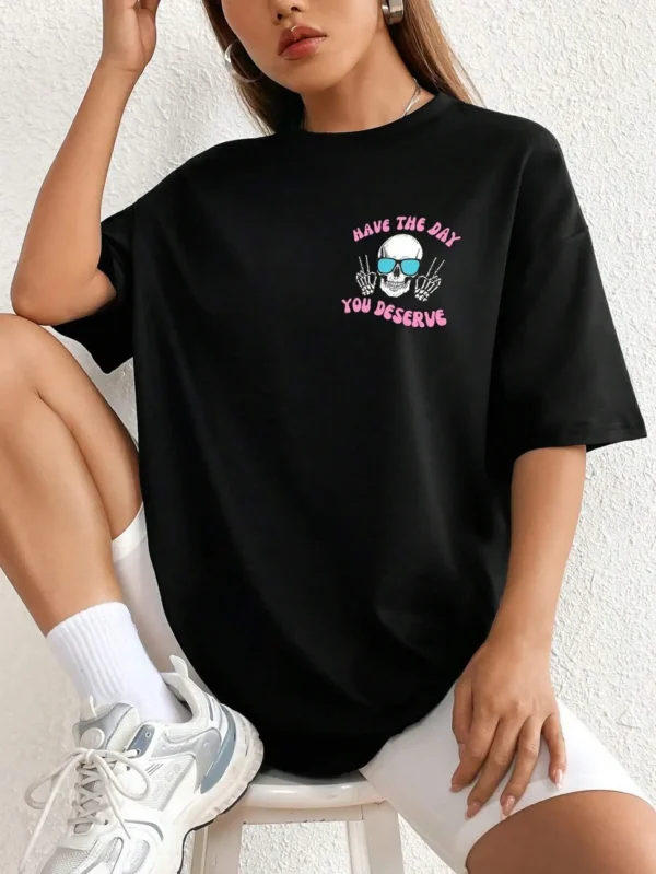 Woman wearing casual white t-shirt with black 'Have The Day You Deserve' graphic print.
