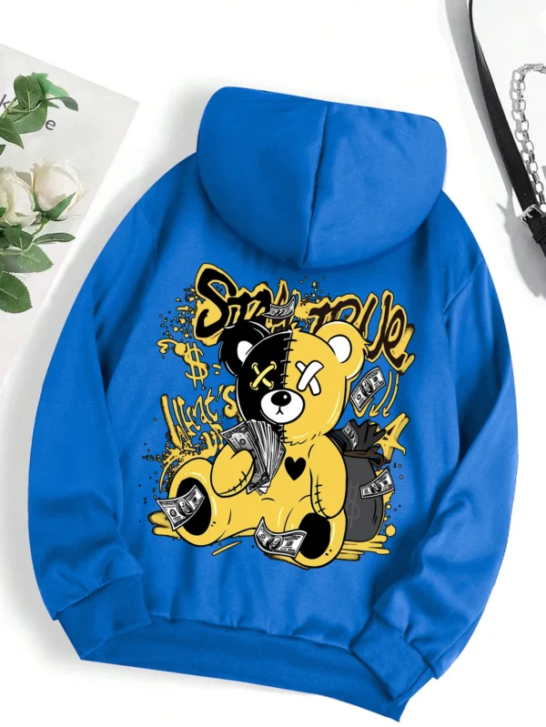 Woman wearing oversized fleece hoodie with large bear cartoon print - Harajuku streetwear style.