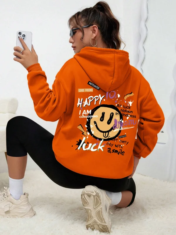 Woman wearing a casual fleece-lined hoodie with a colourful all-over graffiti street art print.