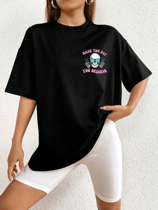 Woman wearing casual white t-shirt with black 'Have The Day You Deserve' graphic print.