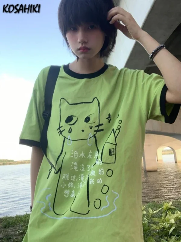 Woman wearing loose-fit Y2K Harajuku graphic tee with colorful cartoon print and contrast details.