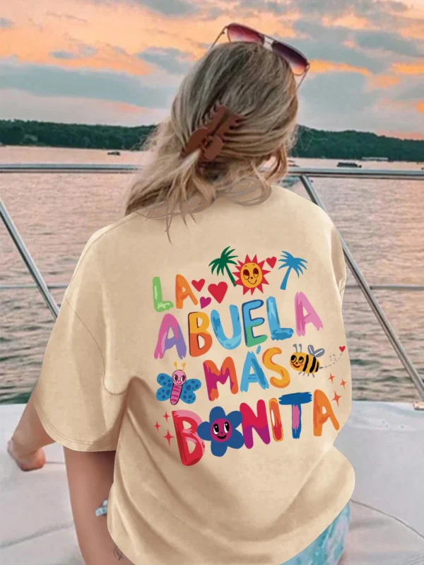 Women's white t-shirt with black text print reading 'La Abuela Más Bonita' (The Most Beautiful Grandmother).