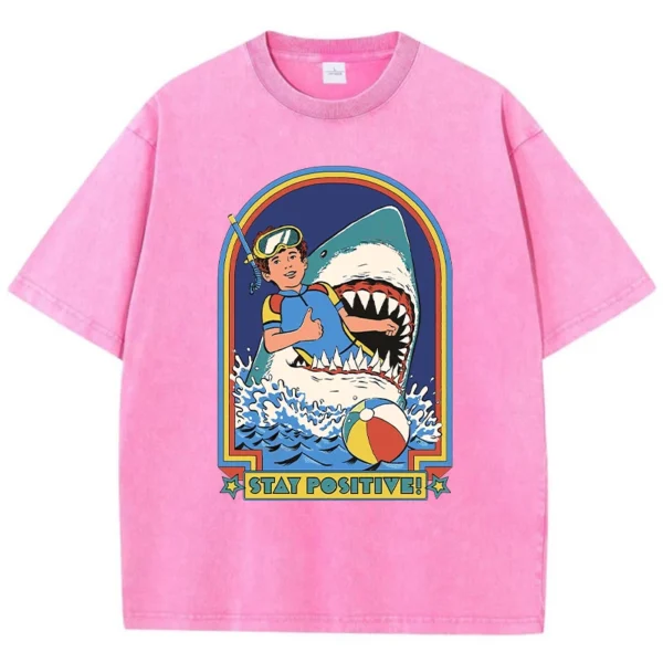 Woman wearing white O-neck t-shirt with colourful "Stay Positive" cartoon graphic print on the front.