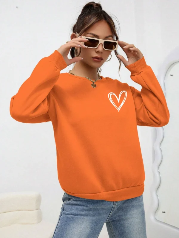 Women's casual crewneck sweatshirt with an all-over heart print pattern and soft fleece lining visible at the collar.
