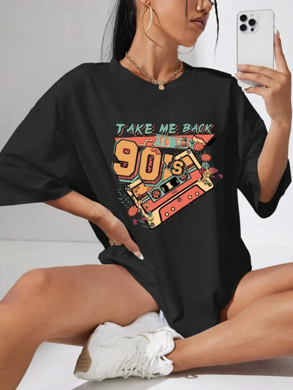 Woman wearing a soft white t-shirt with a colorful retro 'Take Me Back 90s' graphic print.