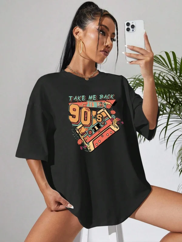 Woman wearing a soft white t-shirt with a colorful retro 'Take Me Back 90s' graphic print.