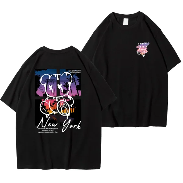 Men's loose fit cotton t-shirt displaying a colorful graphic print of a cartoon bear in front of a New York sunset scene.
