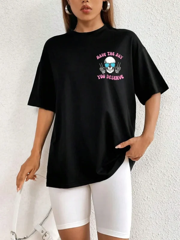 Woman wearing casual white t-shirt with black 'Have The Day You Deserve' graphic print.