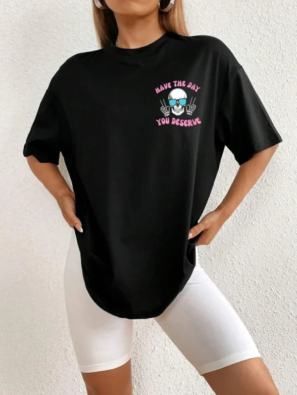 Woman wearing casual white t-shirt with black 'Have The Day You Deserve' graphic print.