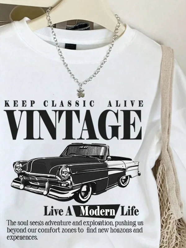 Woman wearing an oversized grey hoodie sweatshirt with a vintage car print