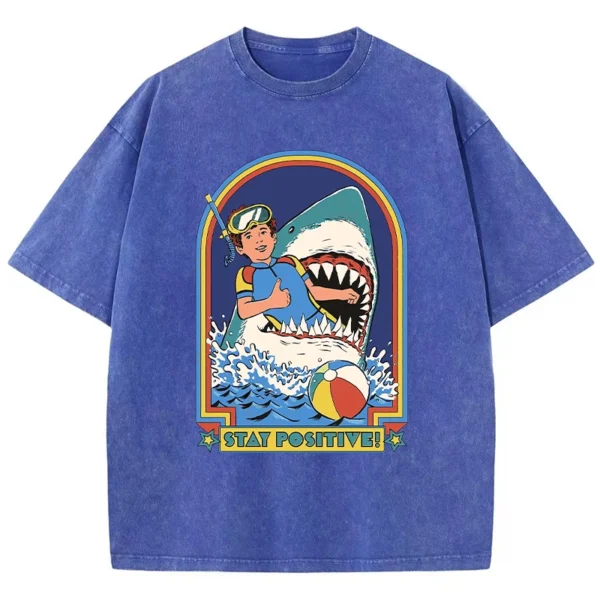 Woman wearing white O-neck t-shirt with colourful "Stay Positive" cartoon graphic print on the front.