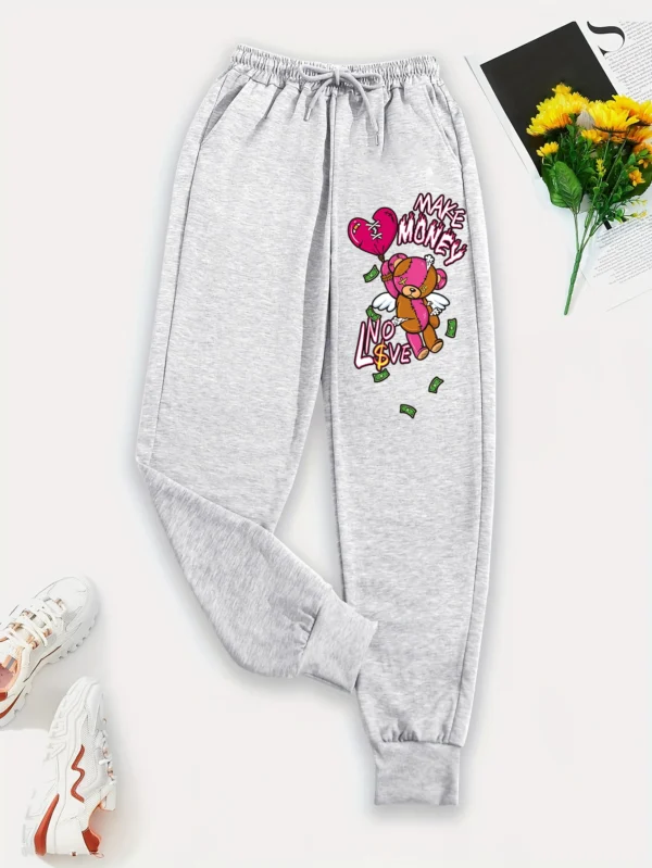 Women's knit streetwear pants featuring a large cartoon bear graphic print on the leg - casual hip hop style.