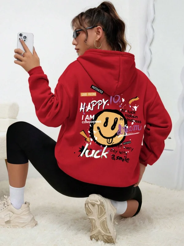 Woman wearing a casual fleece-lined hoodie with a colourful all-over graffiti street art print.