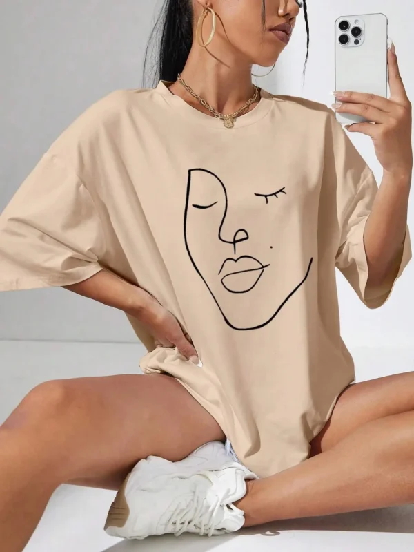 Woman wearing white cotton t-shirt with black minimalist line art face print. Casual short sleeve regular fit style. ```