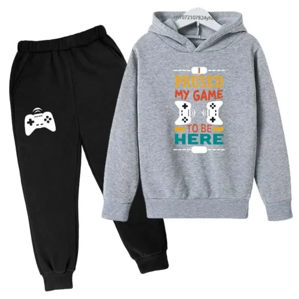 Kids gamer tracksuit set with 'I Paused My Game To Be Here' slogan on hooded sweatshirt and matching pants for boys or girls.