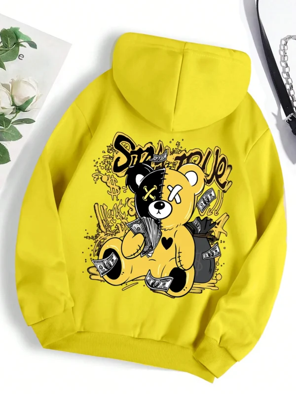 Woman wearing oversized fleece hoodie with large bear cartoon print - Harajuku streetwear style.