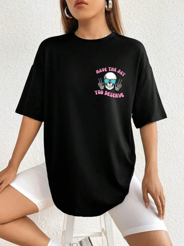 Woman wearing casual white t-shirt with black 'Have The Day You Deserve' graphic print.
