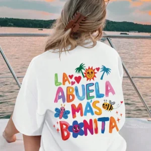 Women's white t-shirt with black text print reading 'La Abuela Más Bonita' (The Most Beautiful Grandmother).
