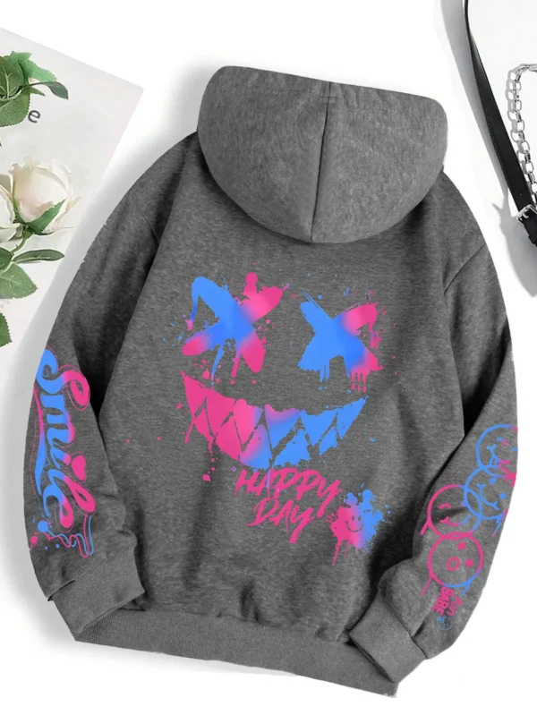 Front view of a woman wearing the oversized graffiti print hoodie