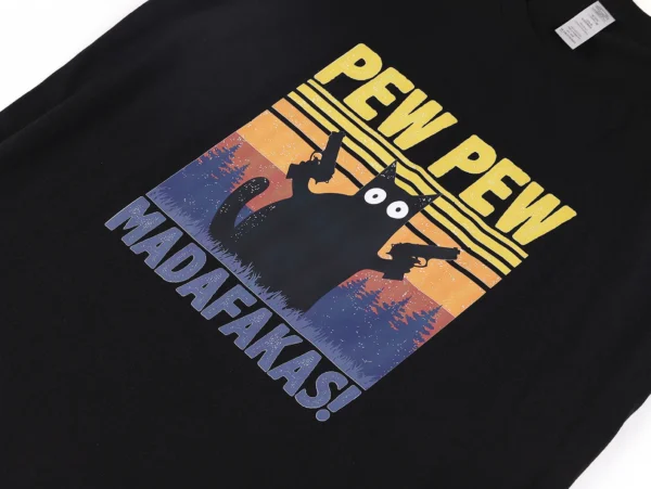 Man wearing black cotton t-shirt with funny graphic of a cat holding guns that reads 'Pew Pew Madafakas'.