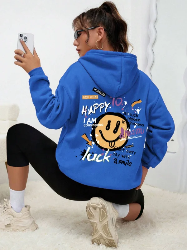 Woman wearing a casual fleece-lined hoodie with a colourful all-over graffiti street art print.