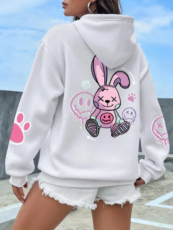 Woman wearing oversized black printed streetwear hoodie with artificial fur lining