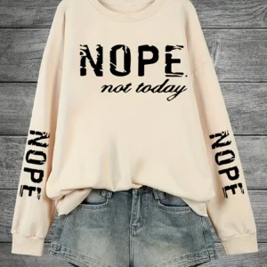 Woman wearing a "Nope Not Today" retro print sweatshirt.