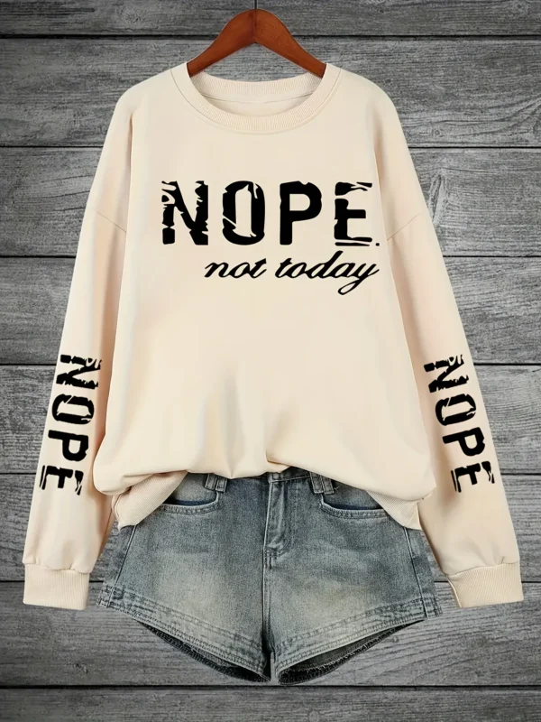 Woman wearing a "Nope Not Today" retro print sweatshirt.