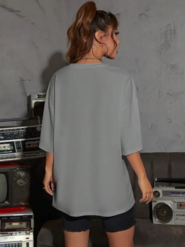 Woman wearing casual white t-shirt with retro "Brooklyn 1976 New York" graphic print.