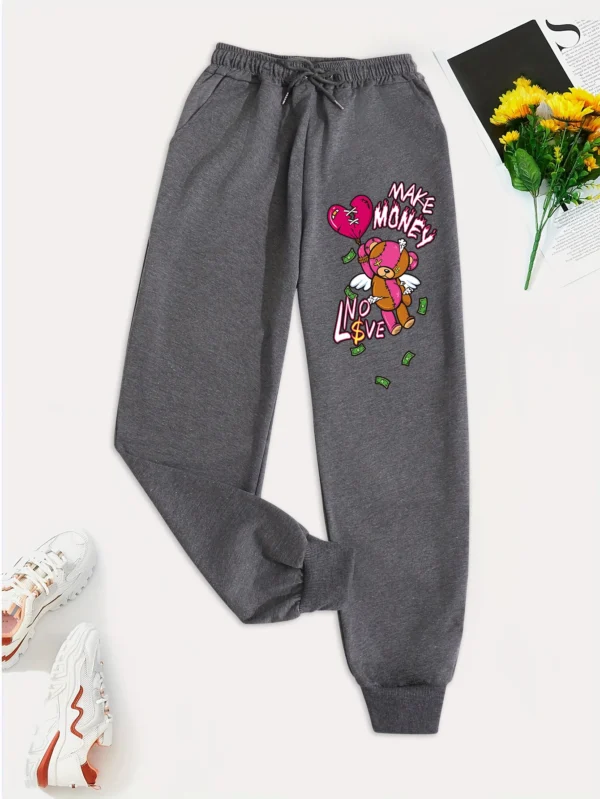 Women's knit streetwear pants featuring a large cartoon bear graphic print on the leg - casual hip hop style.