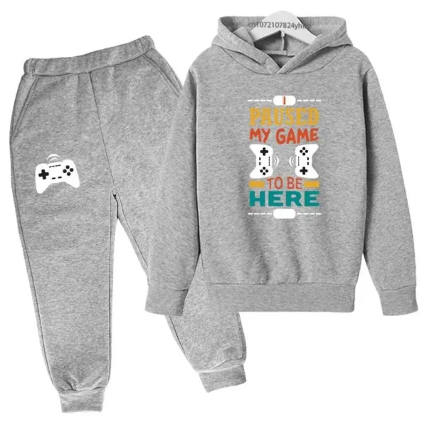 Kids gamer tracksuit set with 'I Paused My Game To Be Here' slogan on hooded sweatshirt and matching pants for boys or girls.