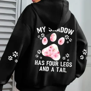 Woman wearing a "My Shadow Has Four Legs" fleece hoodie.