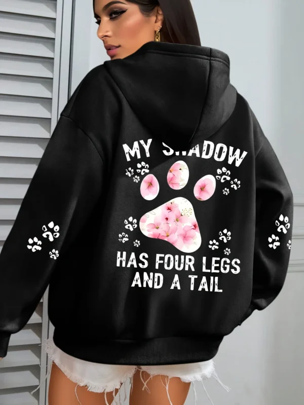 Woman wearing a "My Shadow Has Four Legs" fleece hoodie.