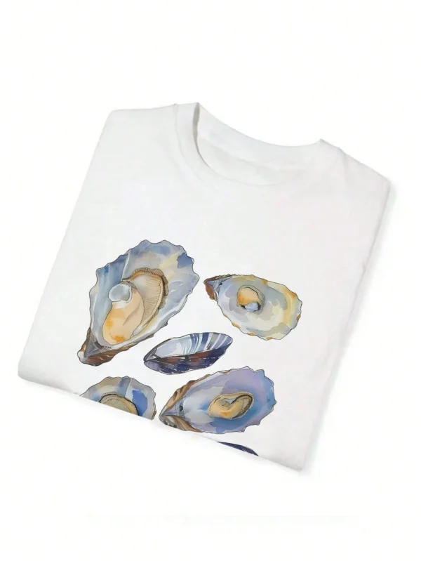 Woman wearing a casual white t-shirt with a blue and beige vintage seashell print.