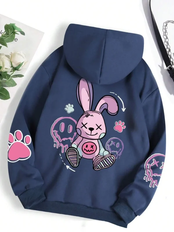 Woman wearing oversized black printed streetwear hoodie with artificial fur lining