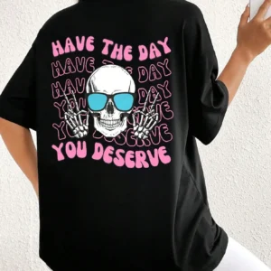 Woman wearing casual white t-shirt with black 'Have The Day You Deserve' graphic print.