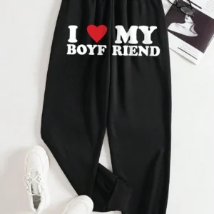 Women's black loose fit drawstring sweatpants with 'I Love My Boyfriend' white graphic print on the leg.