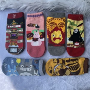 Pair of unisex low cut ankle socks displaying the cartoon anime character Calcifer against a light background. Fits EU 35-37.
