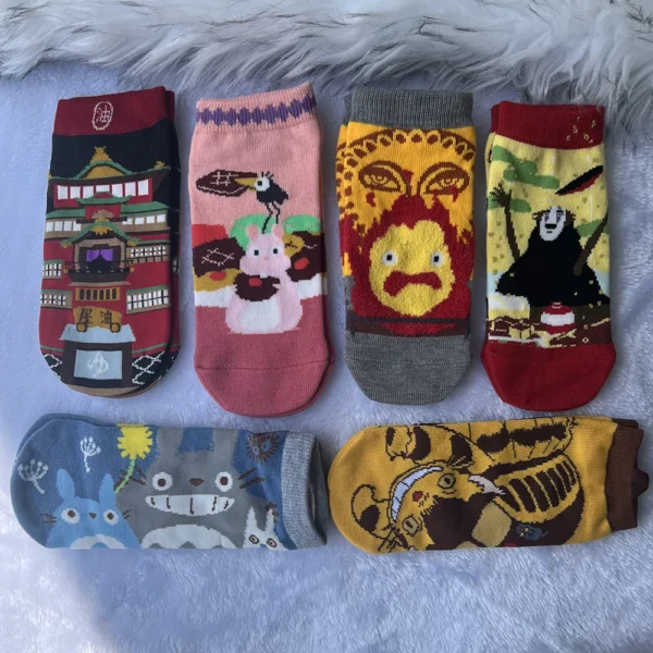 Pair of unisex low cut ankle socks displaying the cartoon anime character Calcifer against a light background. Fits EU 35-37.