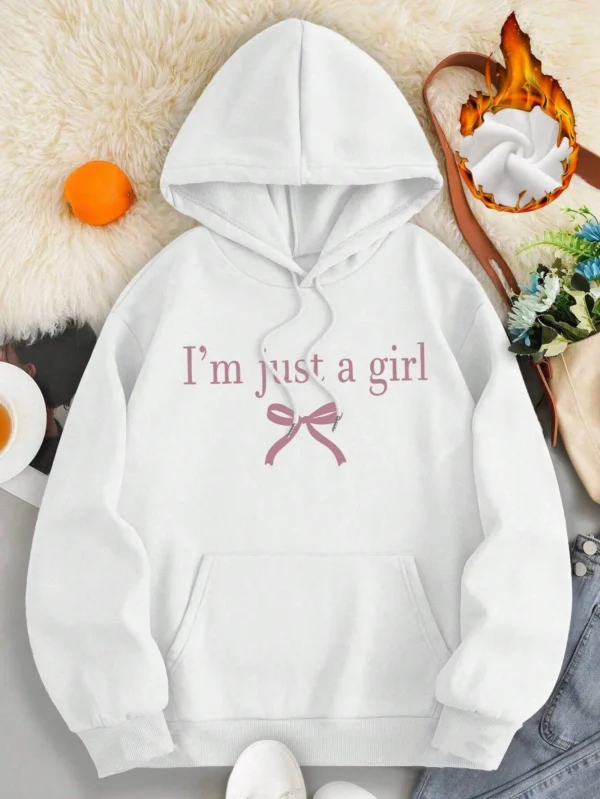 Woman wearing the warm fleece-lined 'I'm Just A Girl' pullover hoodie against a neutral background.