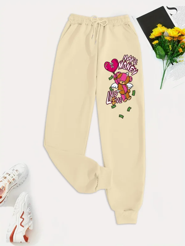 Women's knit streetwear pants featuring a large cartoon bear graphic print on the leg - casual hip hop style.