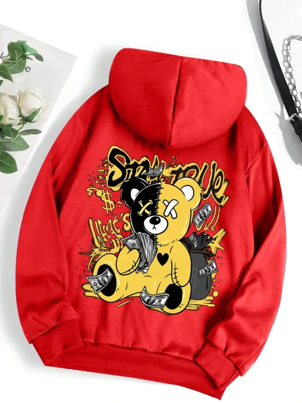 Woman wearing oversized fleece hoodie with large bear cartoon print - Harajuku streetwear style.