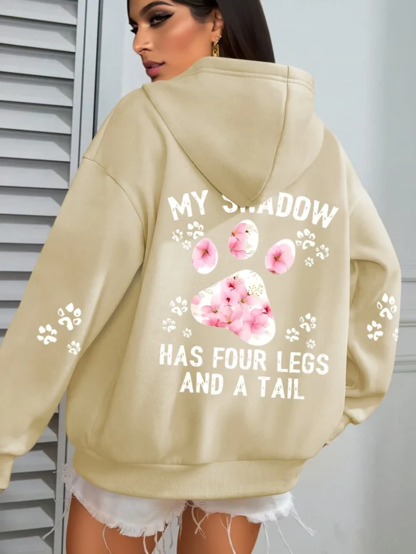 Woman wearing a "My Shadow Has Four Legs" fleece hoodie.