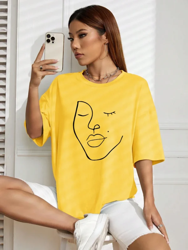 Woman wearing white cotton t-shirt with black minimalist line art face print. Casual short sleeve regular fit style. ```