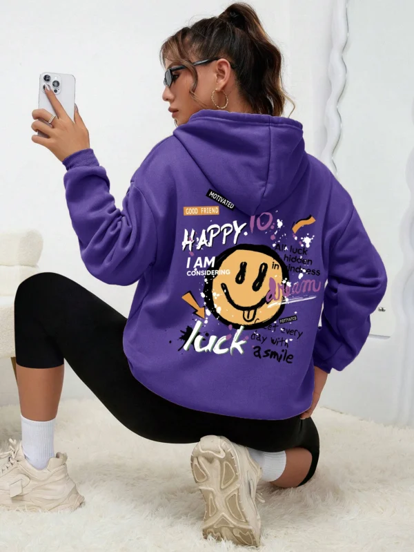 Woman wearing a casual fleece-lined hoodie with a colourful all-over graffiti street art print.