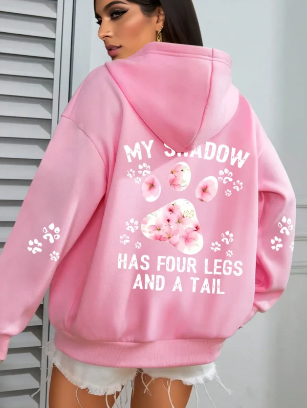 Woman wearing a "My Shadow Has Four Legs" fleece hoodie.