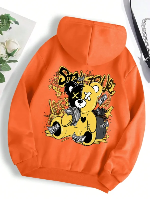 Woman wearing oversized fleece hoodie with large bear cartoon print - Harajuku streetwear style.