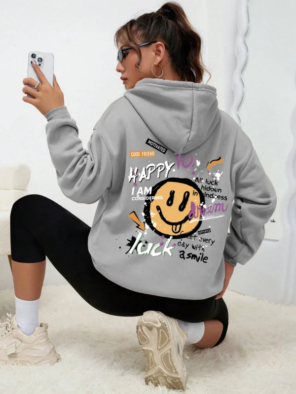Woman wearing a casual fleece-lined hoodie with a colourful all-over graffiti street art print.