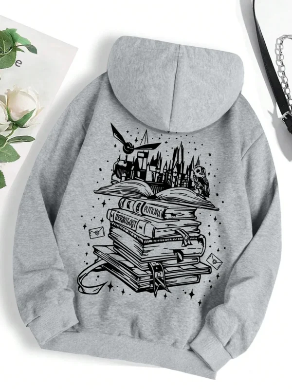 Woman wearing a cozy grey pullover hoodie with a humorous book-themed print on the front