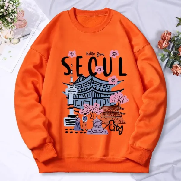 Woman wearing a warm casual hoodie with a colorful Seoul cityscape scenery print.